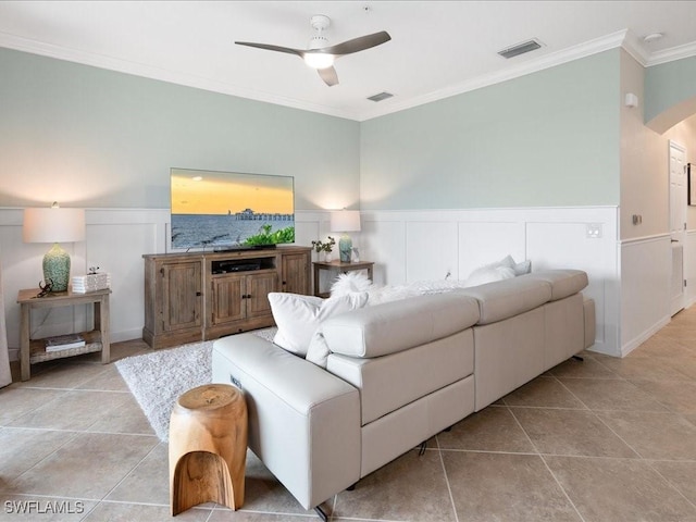 living room with ceiling fan, light tile patterned flooring, and ornamental molding