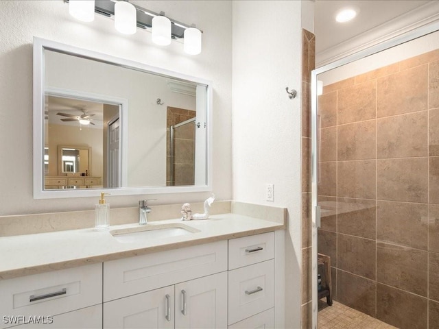 bathroom with ceiling fan, vanity, and walk in shower