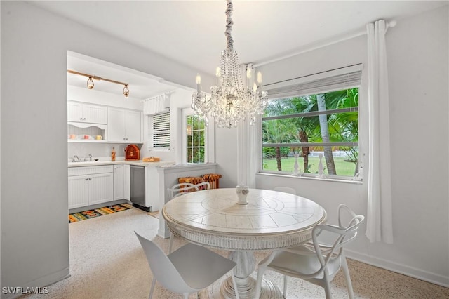 dining area with a notable chandelier and sink