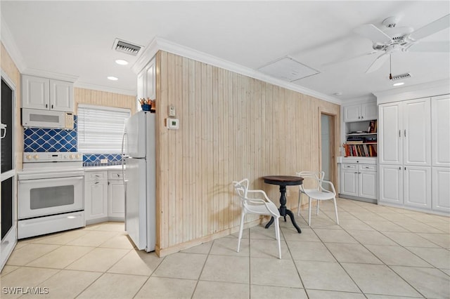 kitchen featuring ceiling fan, ornamental molding, white cabinets, and white appliances