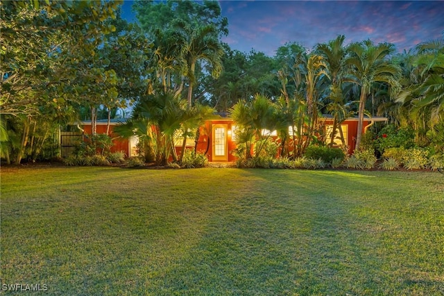 obstructed view of property with a front yard