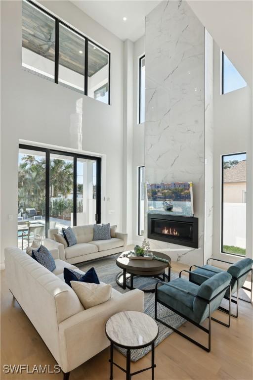 living room featuring a wealth of natural light and a towering ceiling