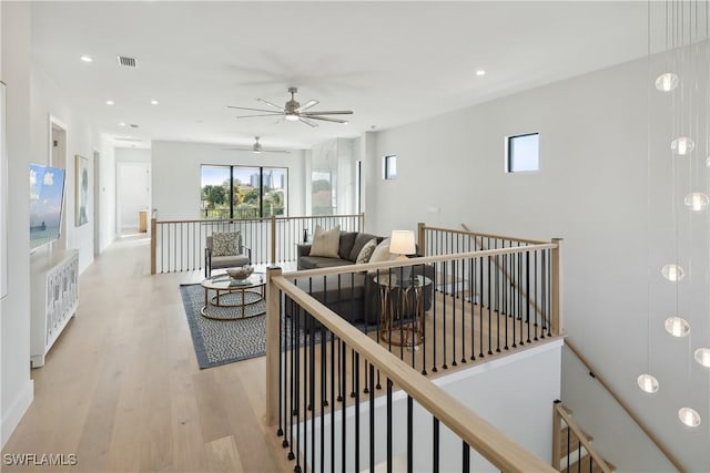 living room featuring light wood-type flooring and ceiling fan