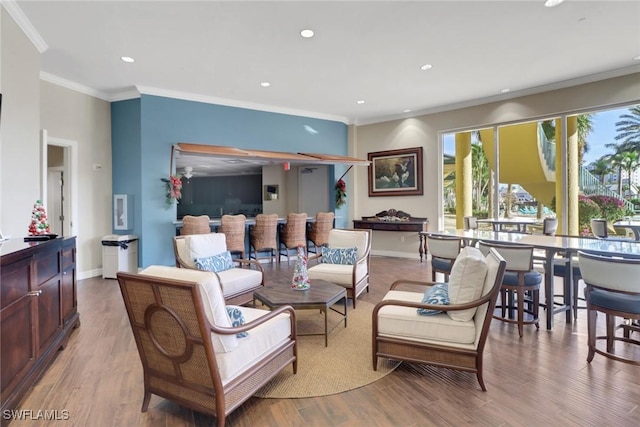 living room with ornamental molding and light wood-type flooring