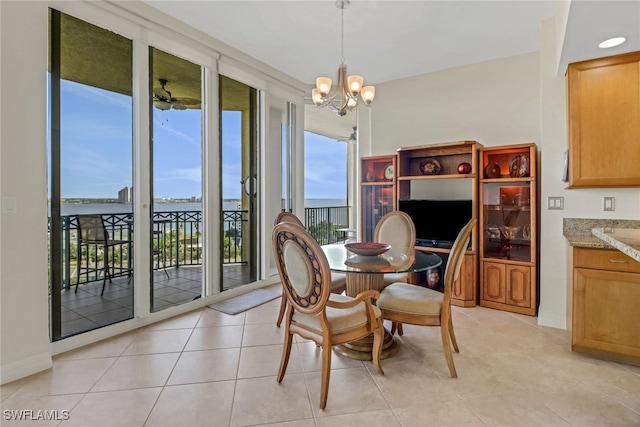 dining space with light tile patterned floors and a notable chandelier