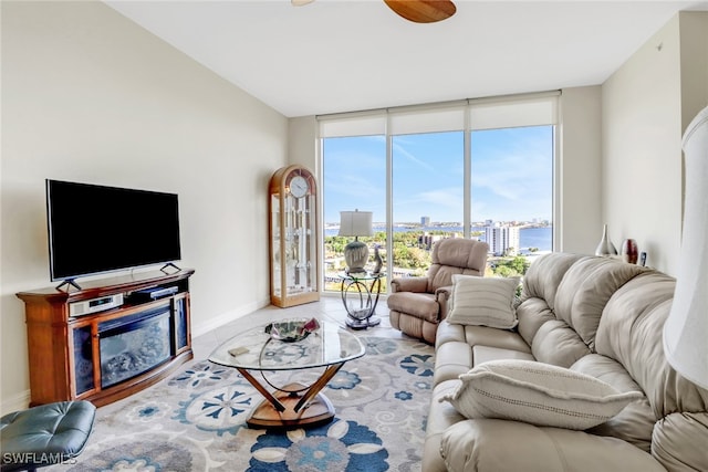 tiled living room with a water view and floor to ceiling windows