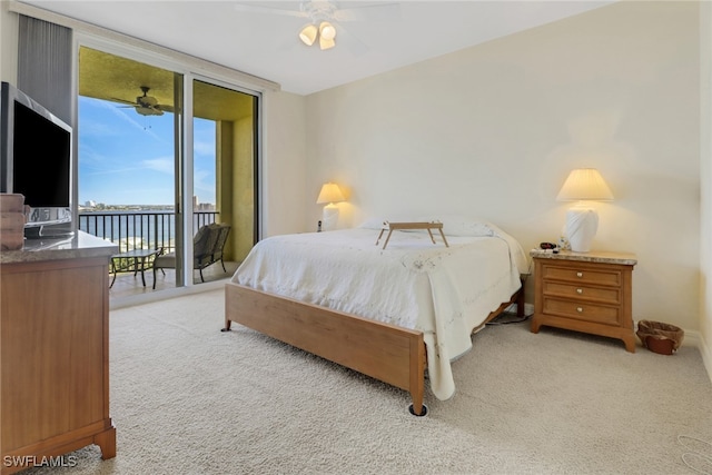 carpeted bedroom featuring ceiling fan, access to outside, and a wall of windows