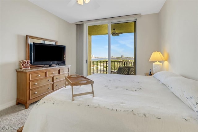 carpeted bedroom featuring access to exterior, expansive windows, and ceiling fan