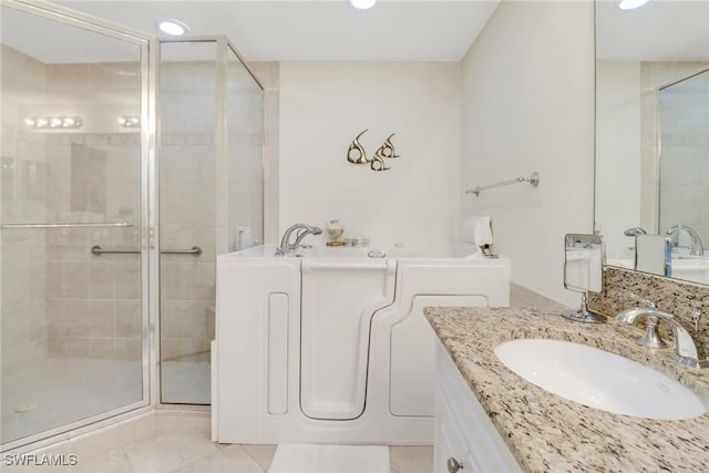 bathroom featuring vanity, separate shower and tub, and tile patterned flooring