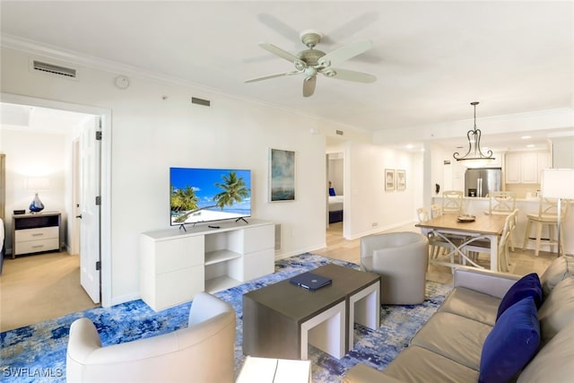 living room featuring ceiling fan and crown molding