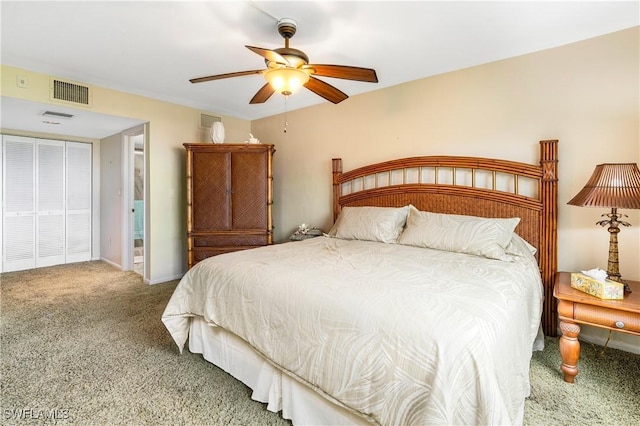 bedroom with ceiling fan, carpet, and a closet