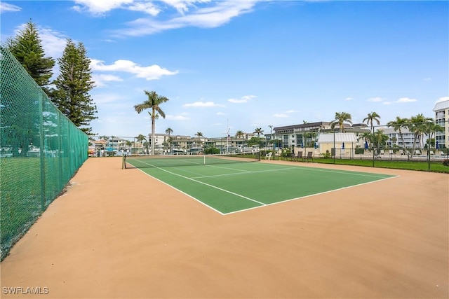 view of tennis court with basketball hoop