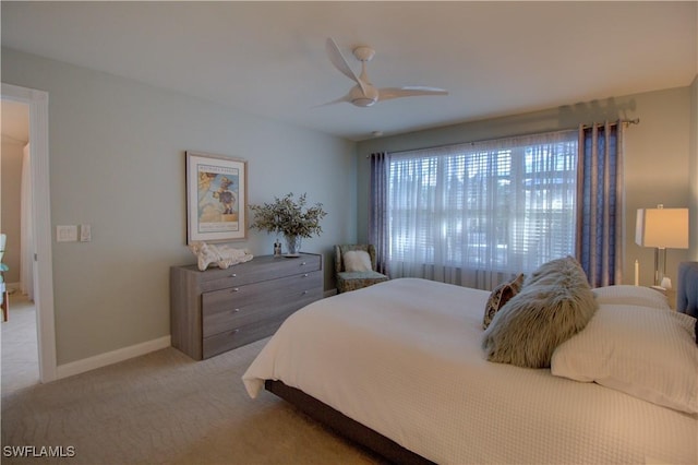 bedroom with ceiling fan and light colored carpet