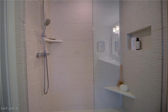 interior details featuring a tile shower