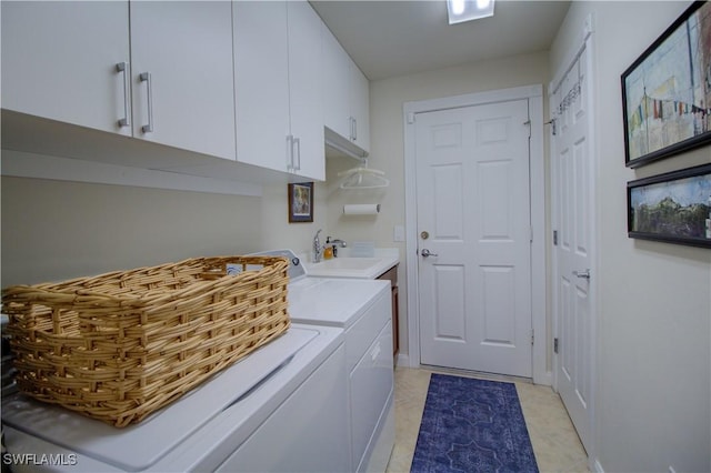 washroom featuring washer and clothes dryer, sink, and cabinets