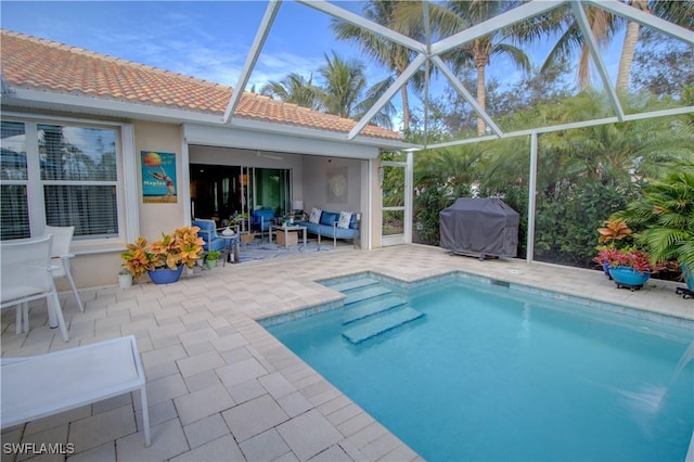 view of pool with an outdoor hangout area, a grill, a lanai, and a patio