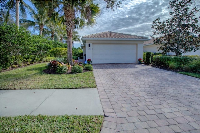 view of front of property featuring a garage and a front lawn