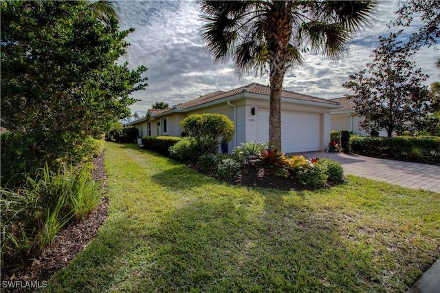 view of side of home with a garage and a lawn