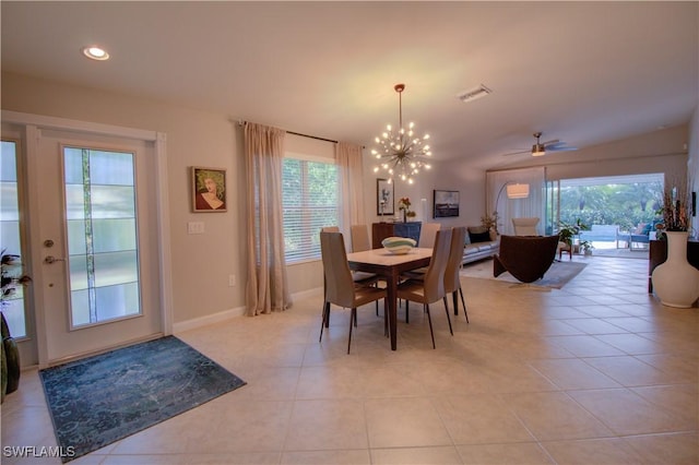 tiled dining area featuring ceiling fan with notable chandelier and plenty of natural light