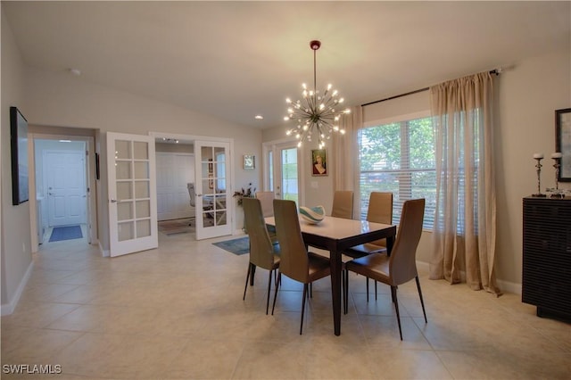 tiled dining room featuring lofted ceiling, french doors, and an inviting chandelier