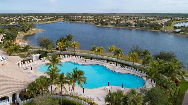 view of pool with a water view and a patio