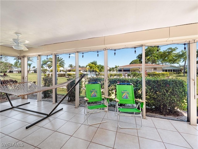 unfurnished sunroom with a wealth of natural light and ceiling fan