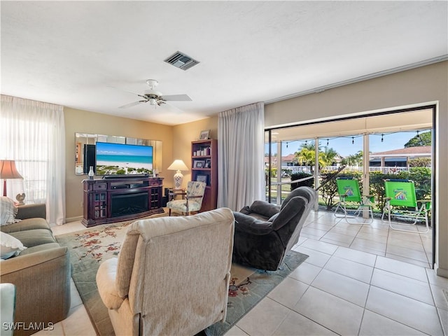 living room with ceiling fan and light tile patterned floors