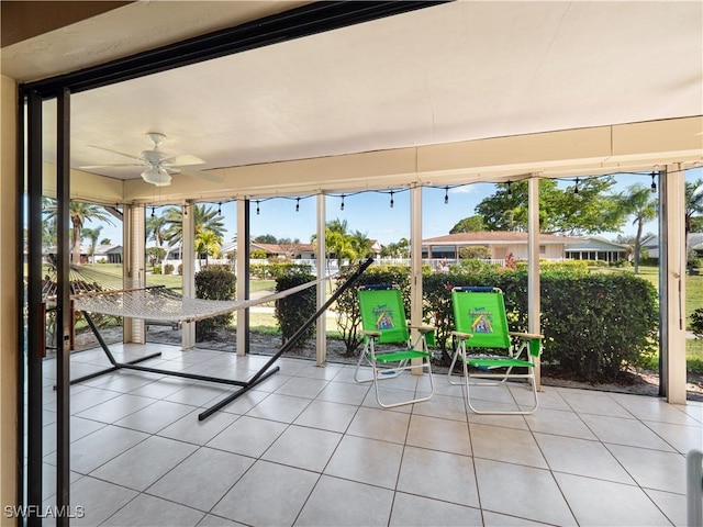 unfurnished sunroom with ceiling fan