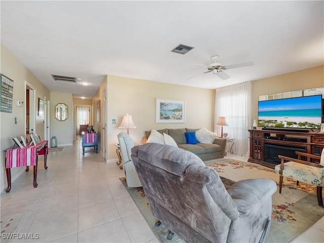 tiled living room with ceiling fan