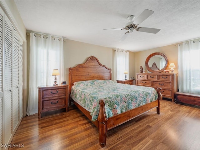 bedroom featuring ceiling fan, hardwood / wood-style floors, and a closet