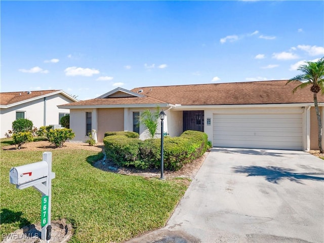 single story home featuring a garage and a front lawn