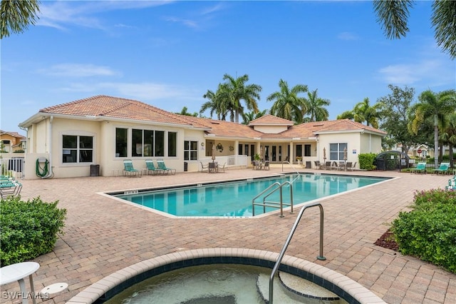 view of pool featuring a patio area and a community hot tub