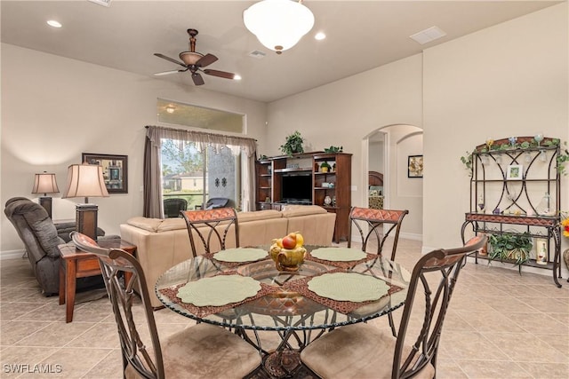 dining area with light tile patterned flooring and ceiling fan