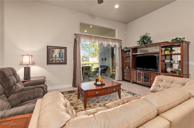 tiled living room featuring ceiling fan