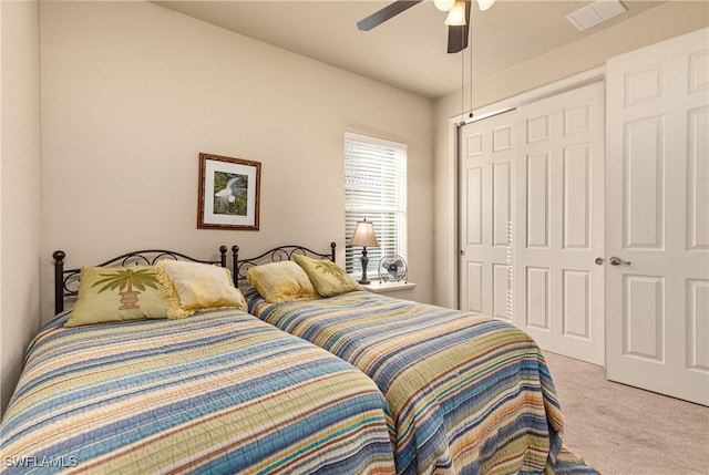 carpeted bedroom featuring a closet and ceiling fan