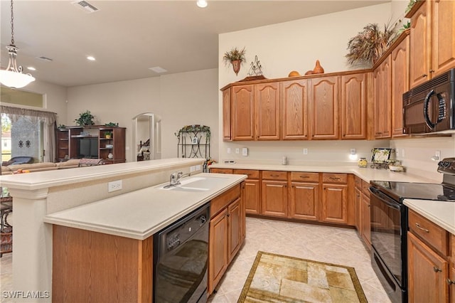 kitchen featuring sink, a center island with sink, light tile patterned floors, pendant lighting, and black appliances