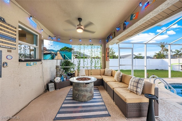 view of patio / terrace with an outdoor living space with a fire pit and glass enclosure