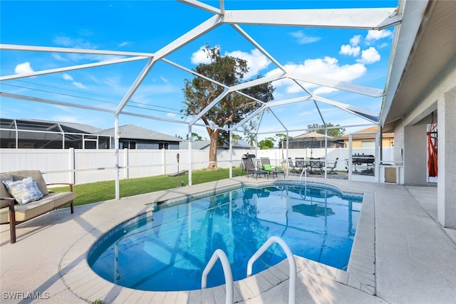 view of swimming pool featuring a patio, glass enclosure, a yard, and a grill