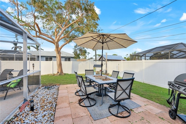 view of patio with a lanai and a grill