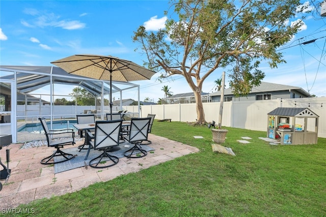 view of yard with a patio, a fenced in pool, and glass enclosure