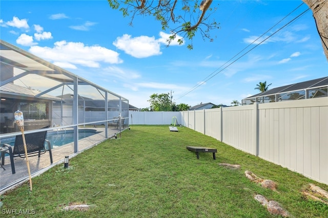 view of yard featuring glass enclosure and a fenced in pool