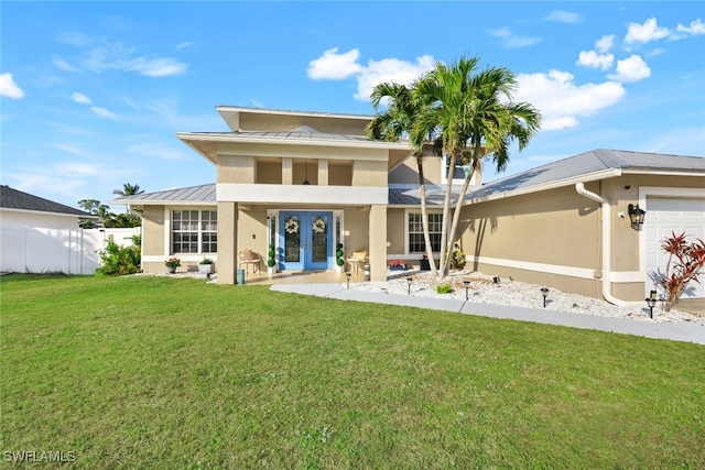 rear view of property with french doors and a lawn