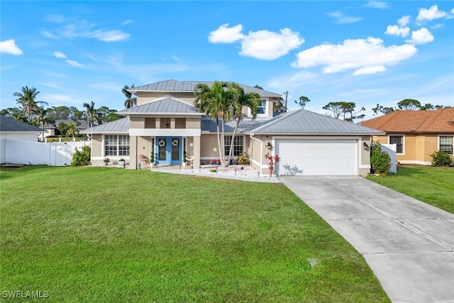 view of front of house featuring a front lawn and a garage