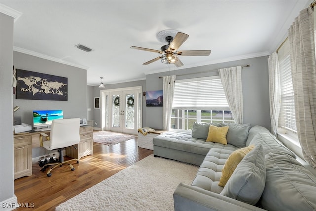 living room with ceiling fan, dark hardwood / wood-style flooring, ornamental molding, and a wealth of natural light