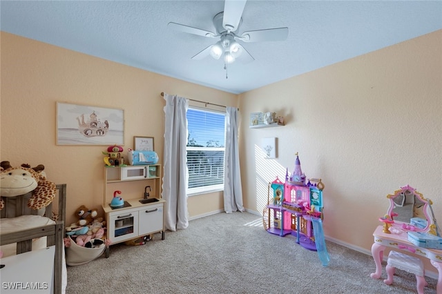 playroom featuring ceiling fan and light colored carpet