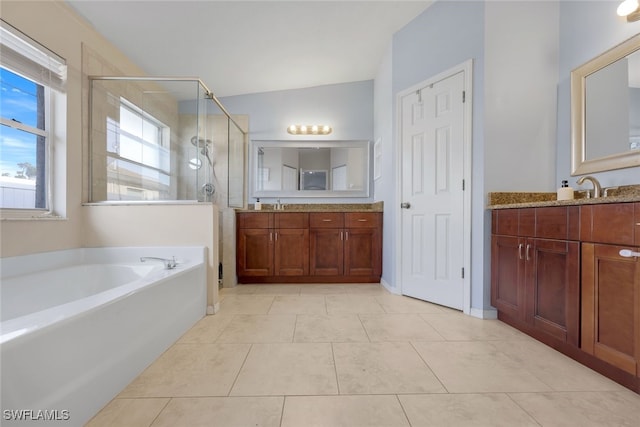 bathroom with tile patterned flooring, plus walk in shower, and vanity