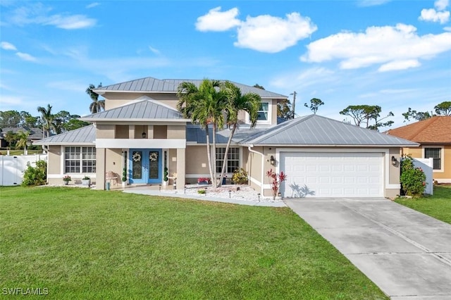 view of front of home featuring french doors, a front lawn, and a garage