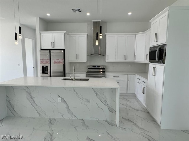 kitchen with wall chimney exhaust hood, decorative light fixtures, stainless steel appliances, a kitchen island with sink, and sink