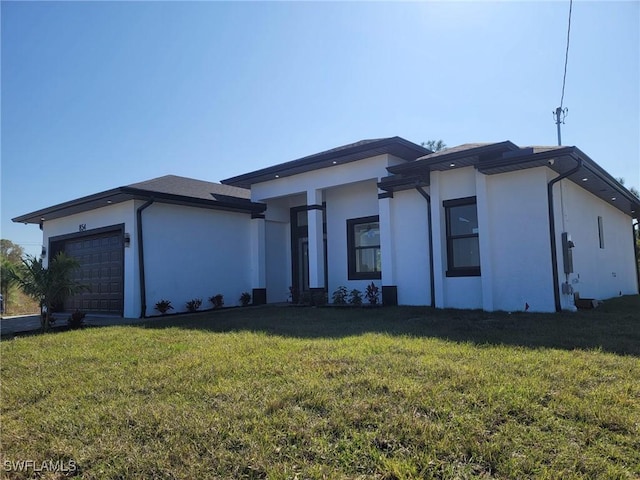 view of front of house featuring a front yard and a garage