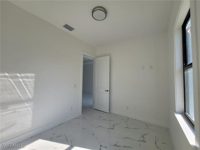 unfurnished room featuring visible vents, marble finish floor, and baseboards